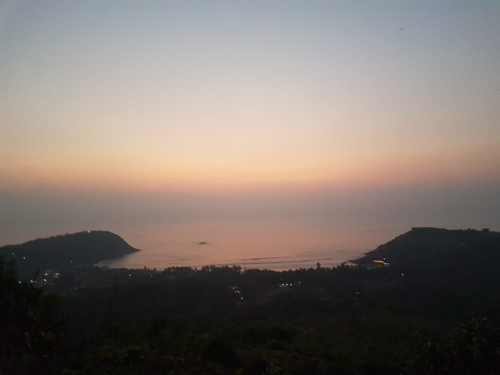 Gokarna Kudle beach aerial view at Sunset with shacks lights sparkling