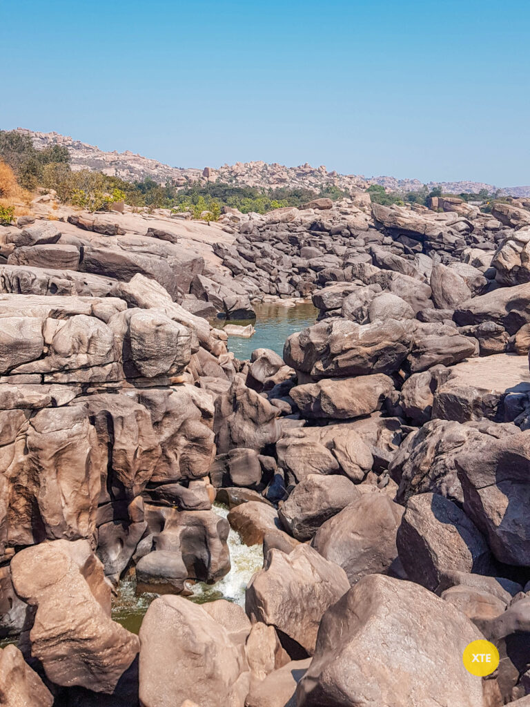 Water gushing through boulders near Hampi Waterfalls