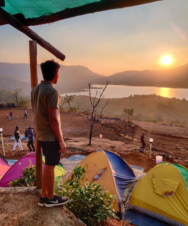 Campsite overseeing the Pawna Lake and the sunset