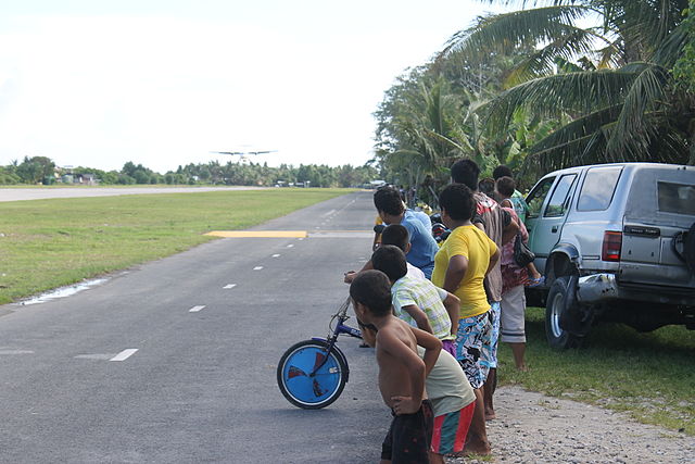Tuvaluan Kids Watching Airplane Land at Funafuti International Airport
