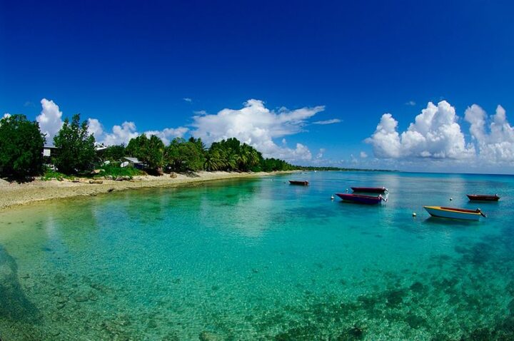 Tuvalu beach with crystal clear water and parked boats