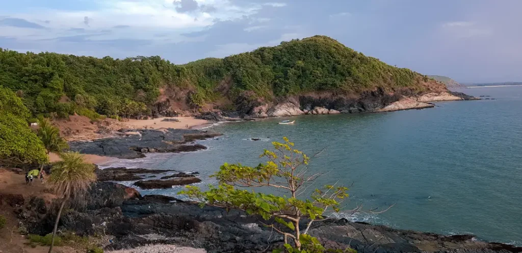 paradise beach visible in distance with the hills and ocean from the trail of gokarna beach trek