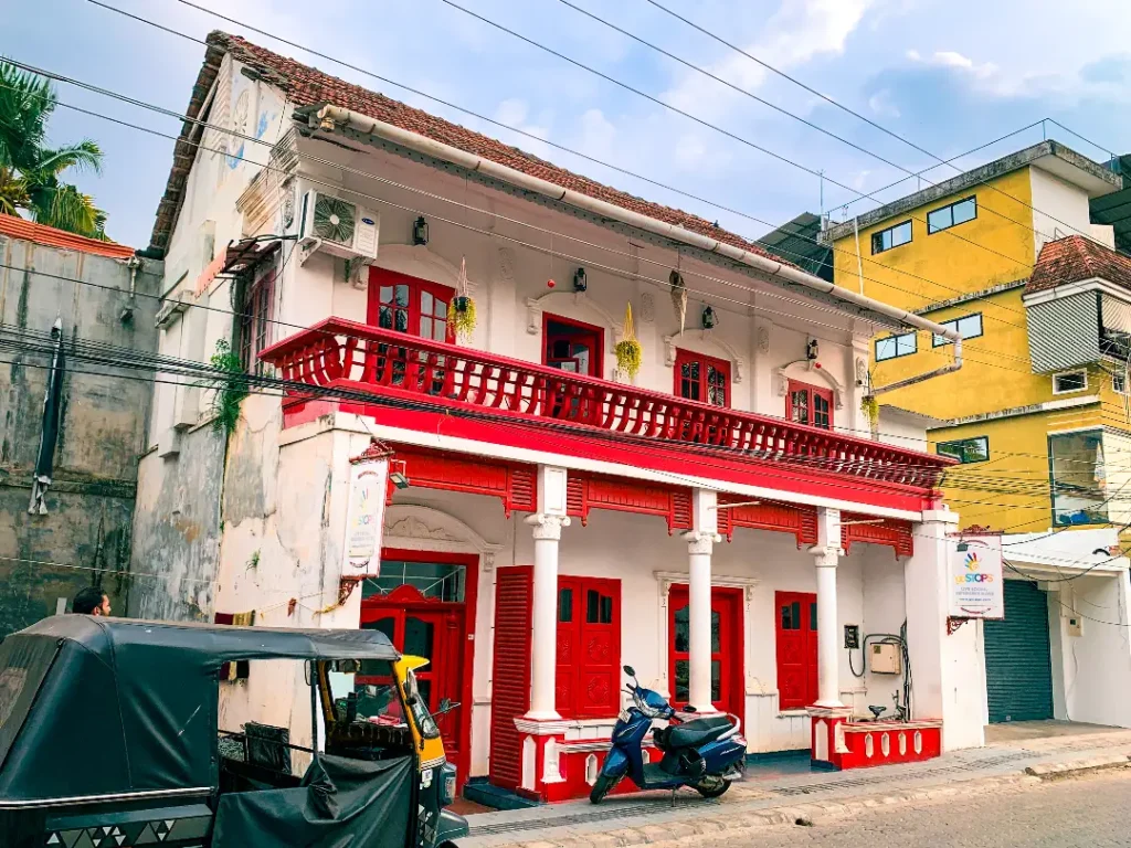 white and red heritage building of gostops in fort kochi kerala